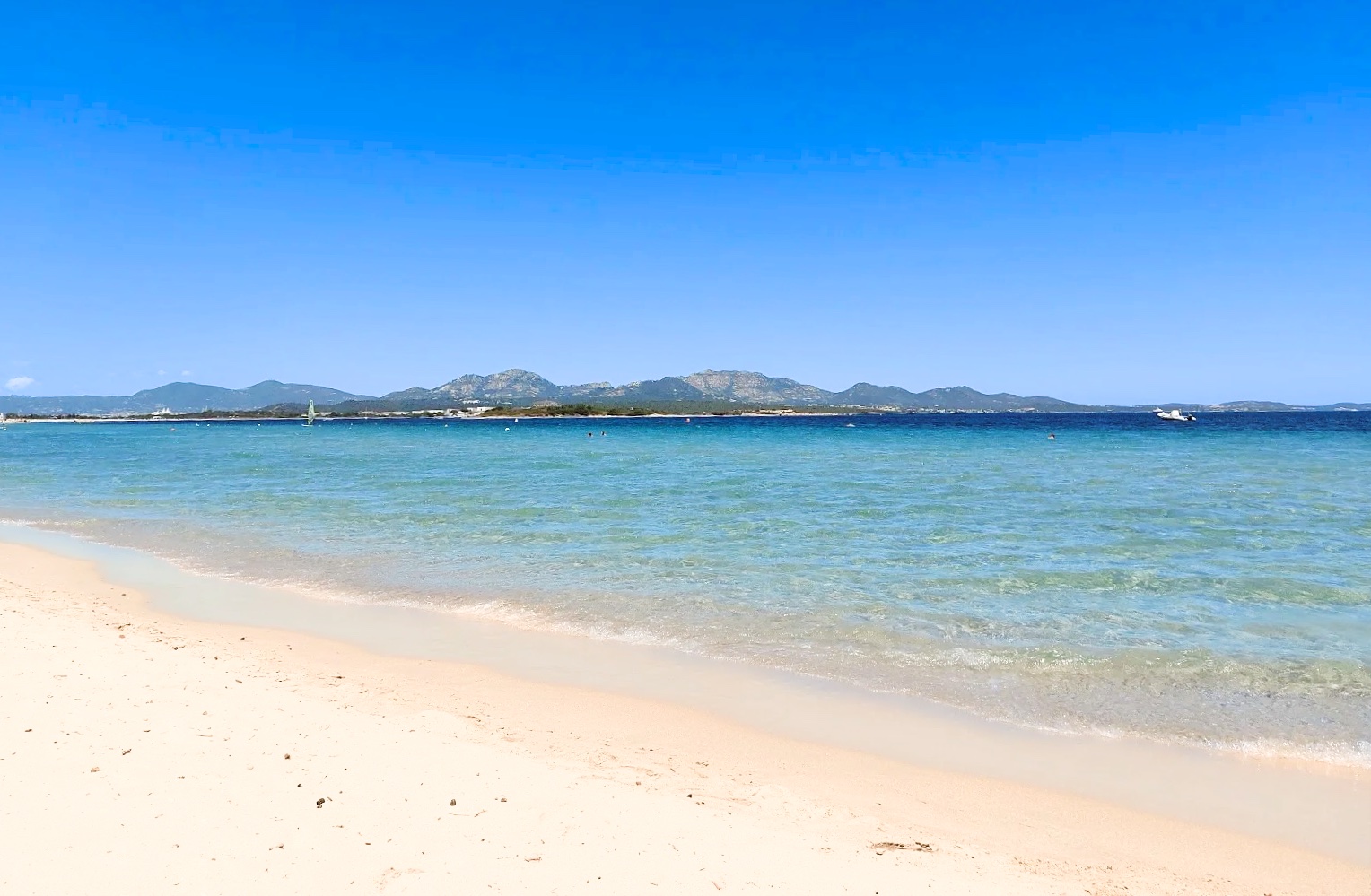 Marina Maria beach near Murta Maria, with shallow water and Tavolara in the distance